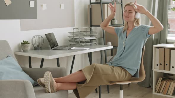 Girl Listening to Music by Desk