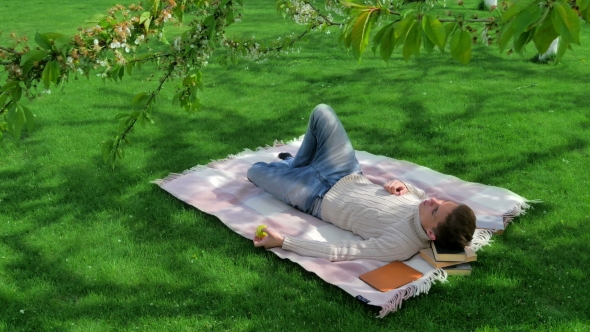 Young Guy Eating Apple In The Yard