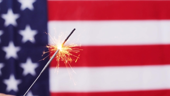  Of Sparkler Burning Over American Flag