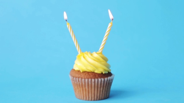 Birthday Cupcake With Two Burning Candles
