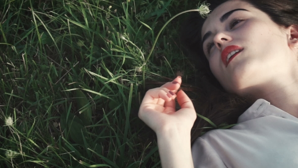 Beautiful Girl Lying On The Grass