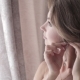 The Young Beautiful Woman Puts On Earrings - VideoHive Item for Sale