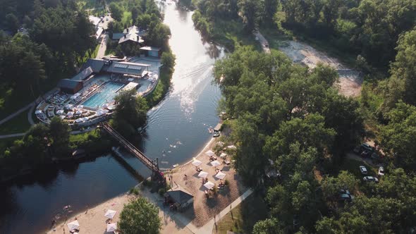 Aerial Top View of River Sand Beach with Hotel Cabins and Pool