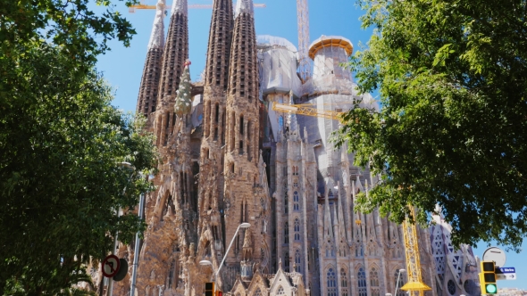 Sagrada Familia, Barcelona, Spain. Summer, On The Background Of Blue Sky