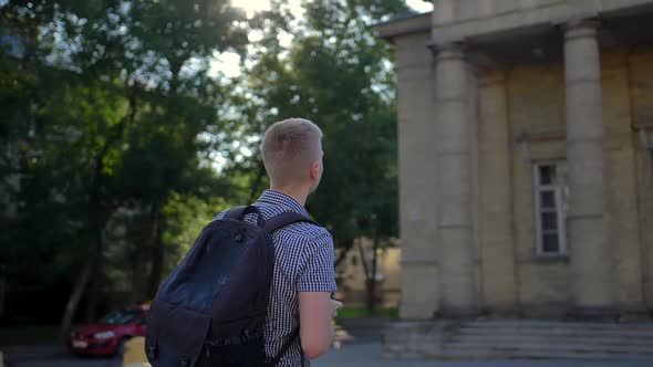 A Young Photographer Approaches the Church and Photographs It