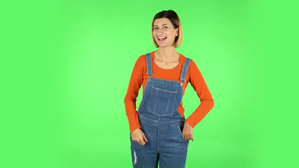 Girl Shows Two Fingers Victory Gesture. Green Screen