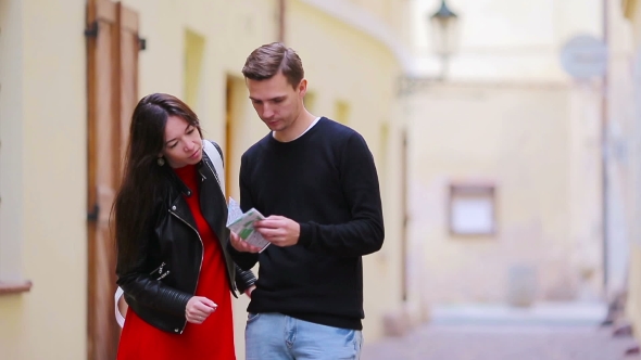 Happy Tourist Couple Traveling On Holidays In Europe Smiling Happy. Caucasian Couple With Citymap