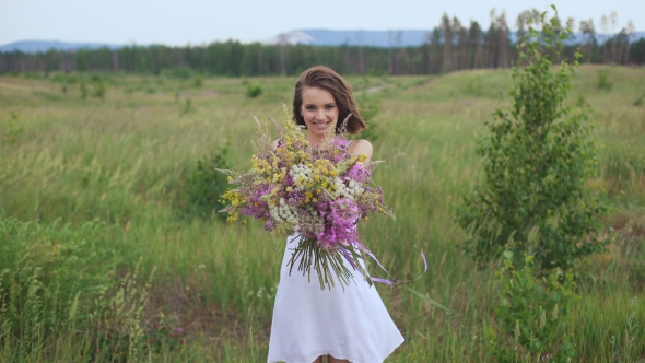 Beautiful Inspired Woman Holds a Bouquet Of Wildflowers.