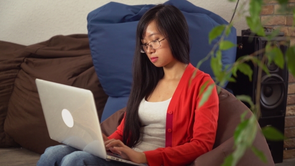 Portrait Young Asian Girl Looking With Smile At The Camera And Chatting Online