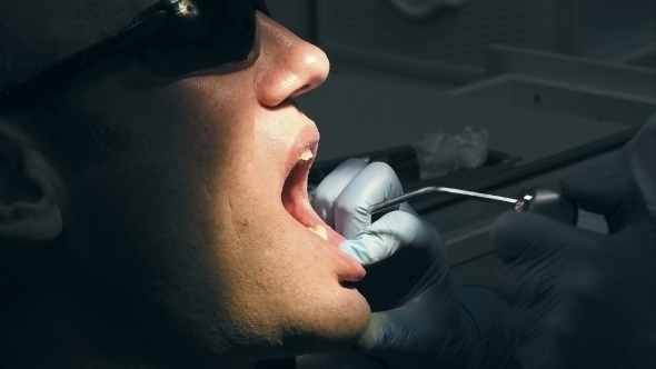 Man Gets Dental Medical Examination And Treatment