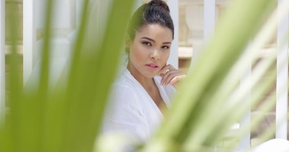 Attractive Young Woman Framed By Palm Leaves