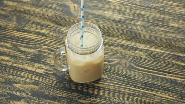 Glass Of Iced Coffee On Wooden Table