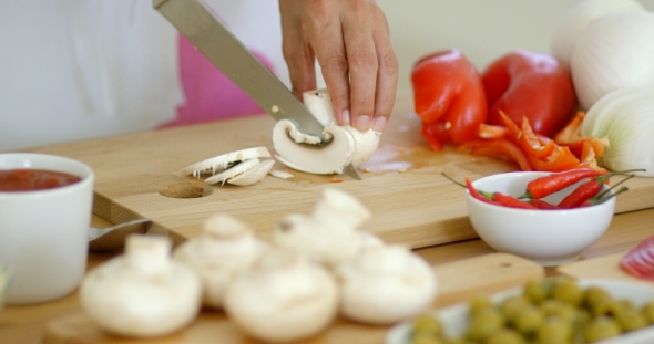 Housewife Preparing Dinner Slicing Fresh Mushrooms