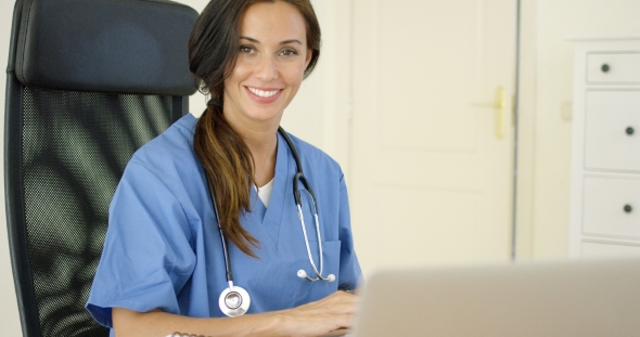 Beautiful Female Doctor At Laptop Computer