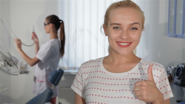 Woman Demonstrates Satisfaction Of Dentist Checkup