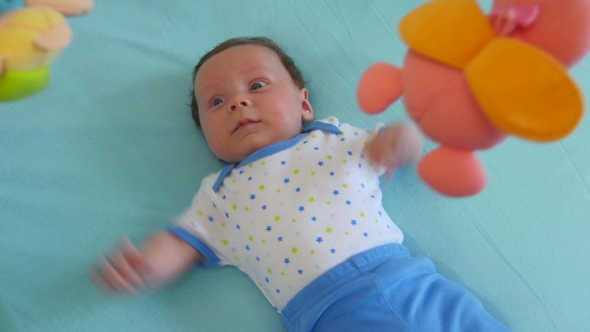 Baby Looking Up At A Mobile Toy