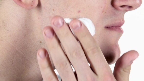 Man Put On Area Of Cheek Shaving Cream. White Background