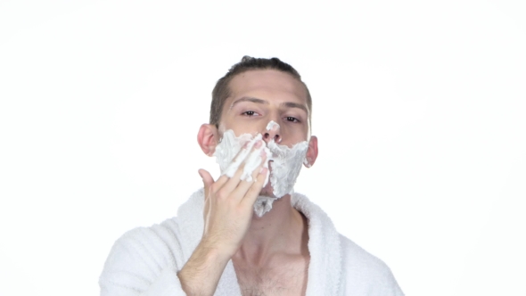 Morning's Procedure. Man Gets Shaving Aid On Face. White Background