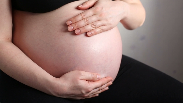 A Pregnant Woman Holding Belly