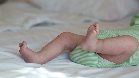 Newborn Baby Lying On a Bed
