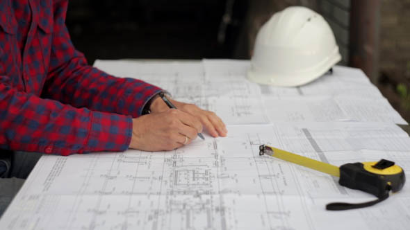 Engineer Designer Checks the Construction Drawings