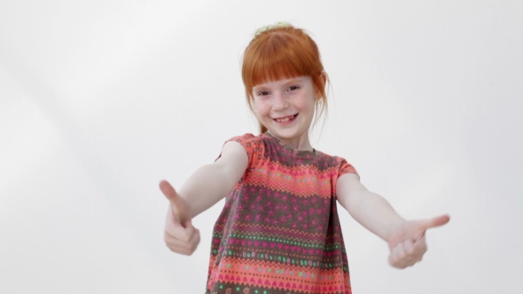 Happy Little Girl Showing Thumb Up Gesture and Smiling