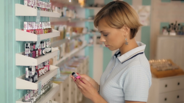 Attractive Woman Customer Buying Nail Polish In Makeup Section. Girl In Supermarket.