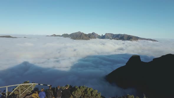 Adventure people stand on scenic viewpoint in mountains during dawn, Madeira