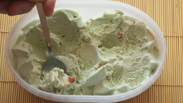 People Take The Pistachio Ice Cream Of a Container