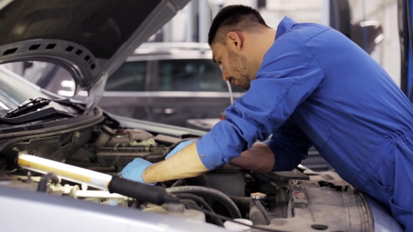 Mechanic Man With Wrench Repairing Car At Workshop 8