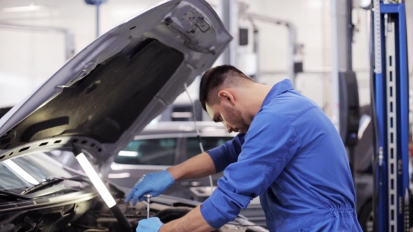 Mechanic Man With Wrench Repairing Car At Workshop 11