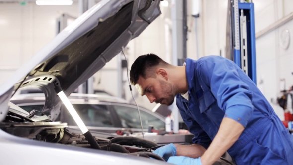 Mechanic Man With Wrench Repairing Car At Workshop 12