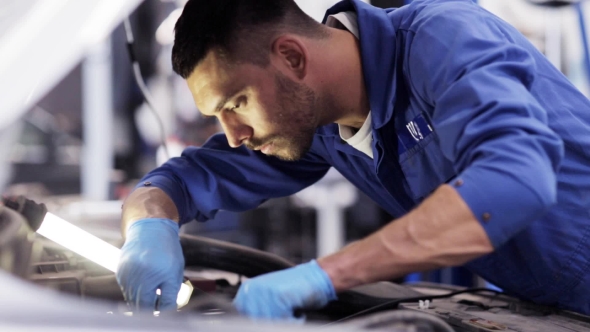 Mechanic Man With Wrench Repairing Car At Workshop 24