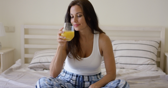 Young Woman Enjoying a Glass Of Orange Juice