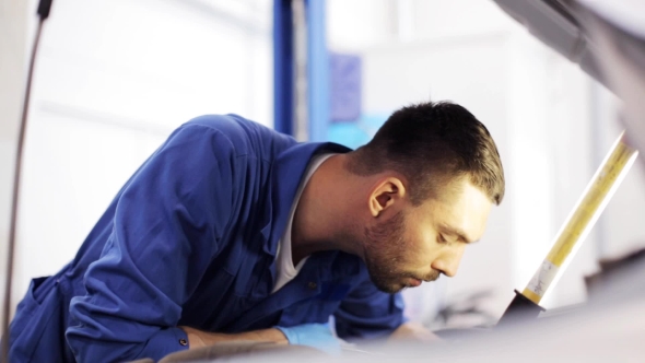 Mechanic Man With Wrench Repairing Car At Workshop 14