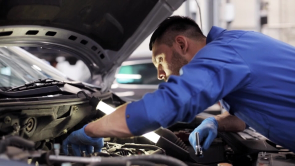 Mechanic Man With Wrench Repairing Car At Workshop 4