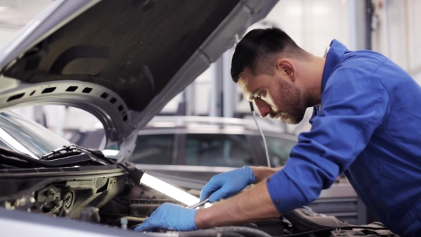 Mechanic Man With Wrench Repairing Car At Workshop 9