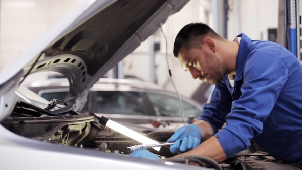 Mechanic Man With Wrench Repairing Car At Workshop 10