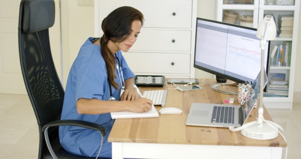 Doctor Working At Her Desk In The Office