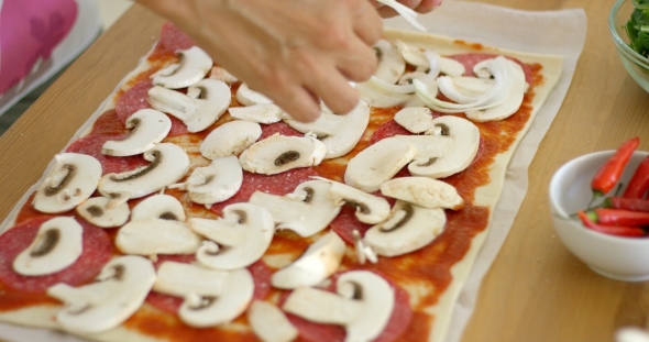 Woman Making a Delicious Pepperoni Pizza