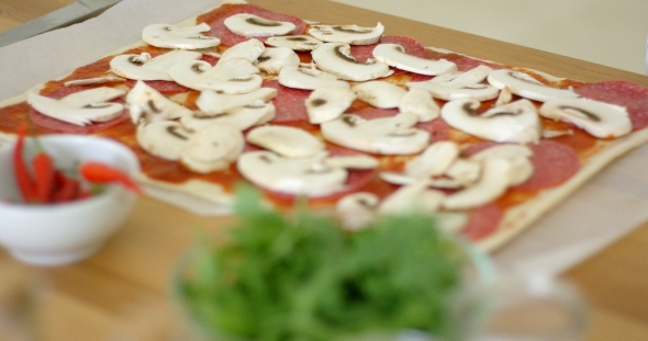 Woman Making a Delicious Pepperoni Pizza