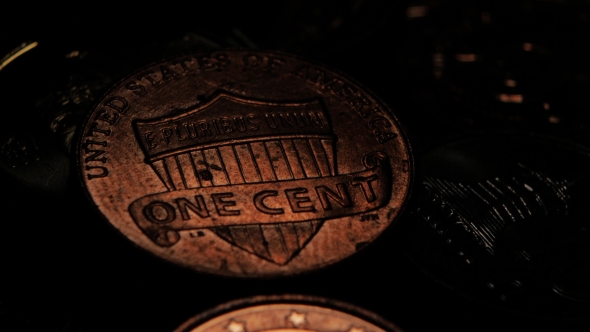 Coin Is Slightly Highlighted In a Dark Room. 