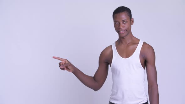 Young Happy African Man Touching Something and Smiling