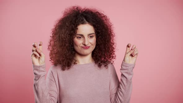 Pretty Curly Girl Showing with Hands and Two Fingers Like Quotes Gesture