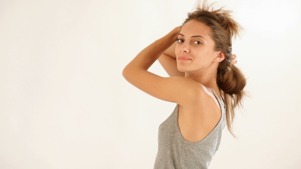 Young Beautiful Lady Playing With Long Hairs In Studio On White