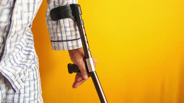 Young Man with Broken Leg on Crutches