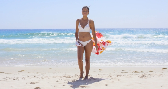Beautiful Young Woman In a Bikini On The Beach
