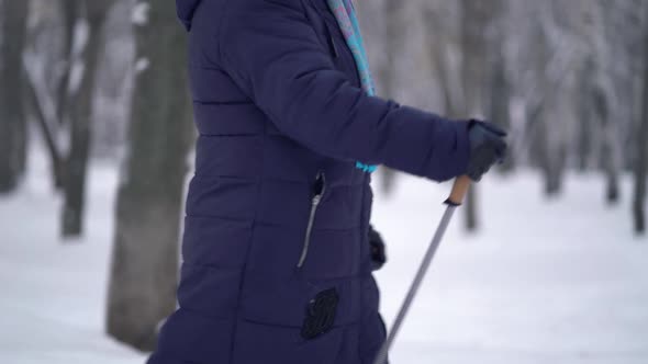 Active Senior Elderly Woman Training Nordic Walking with Trekking Poles. Elderly Woman Practicing