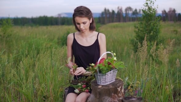 Attractive Brunette Making a Flower Arrangement Of Roses.