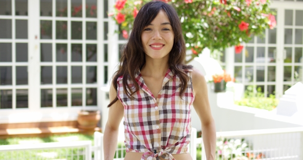 Cute Asian Woman In Tied Plaid Shirt